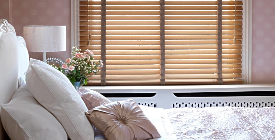 Real wooden blinds with tapes in cosy bedroom