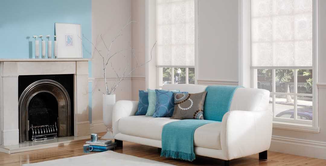 White roller blinds in a blue themed living room