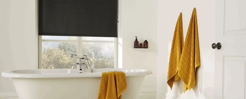 Black made to measure PVC roller blinds in a bathroom
