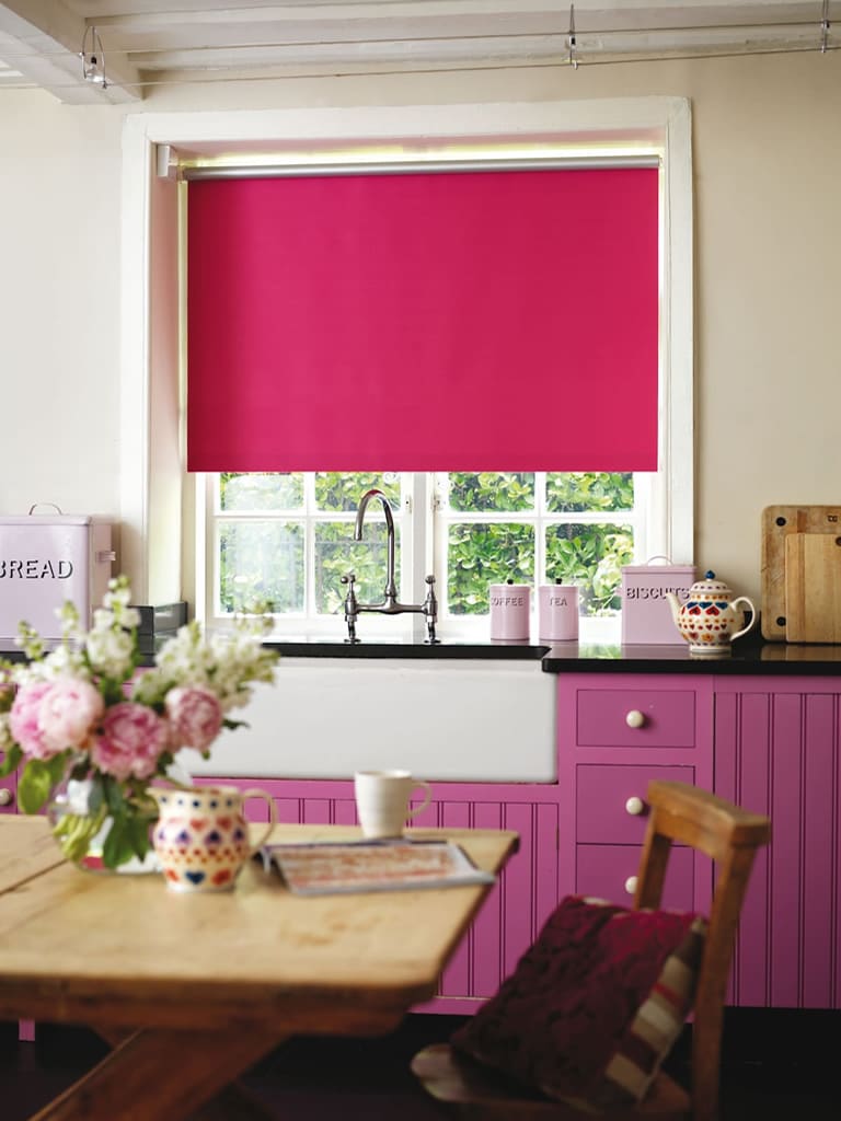 Cerise waterproof PVC roller blinds in a colourful country kitchen