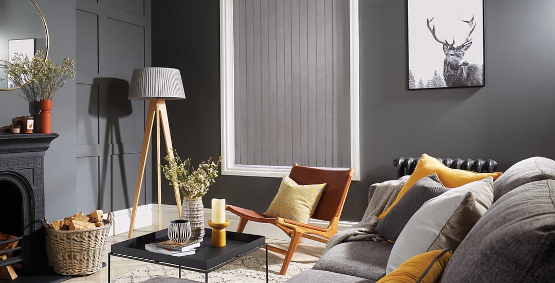 closed grey blackout vertical blinds in cosy living room