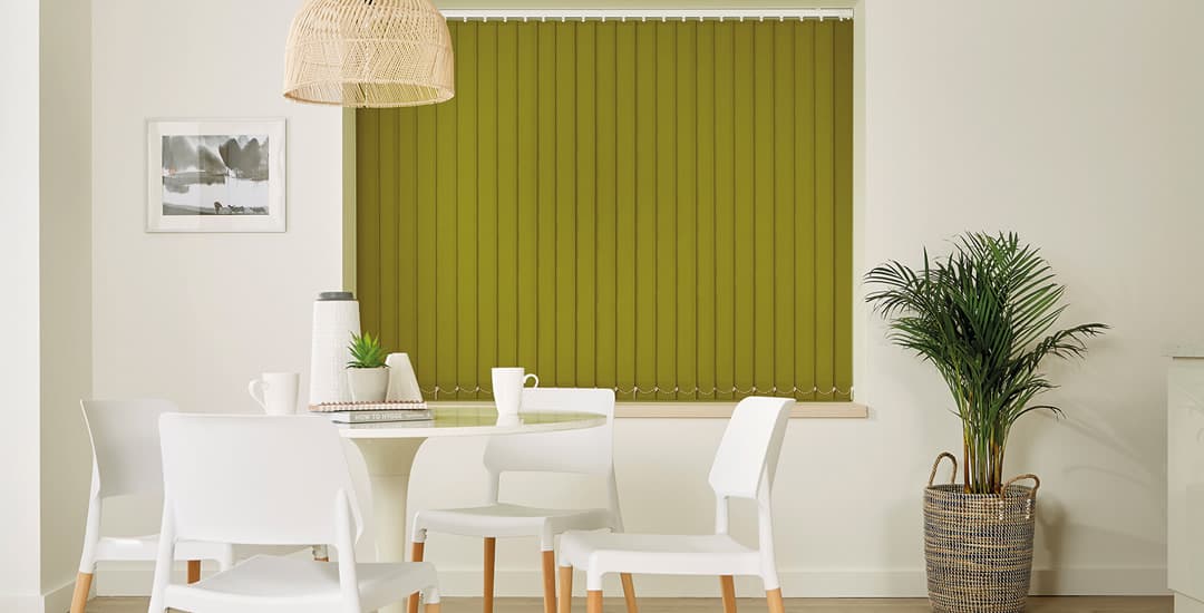 Closed lime green blackout vertical blinds in the dining room