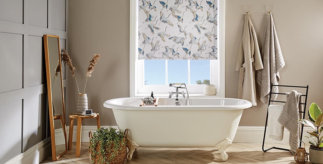 Herons patterned roller blinds in a cosy beige bathroom