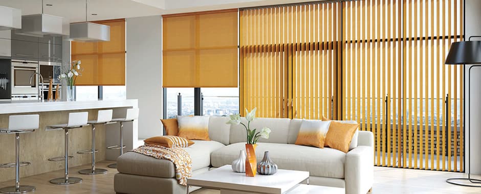 Orange horizontal roller blinds and vertical blinds mixed in a large modern kitchen diner