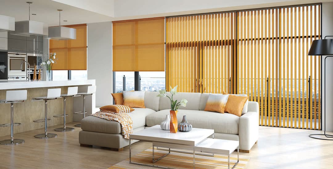 Orange horizontal roller blinds and vertical blinds mixed in a large modern kitchen diner