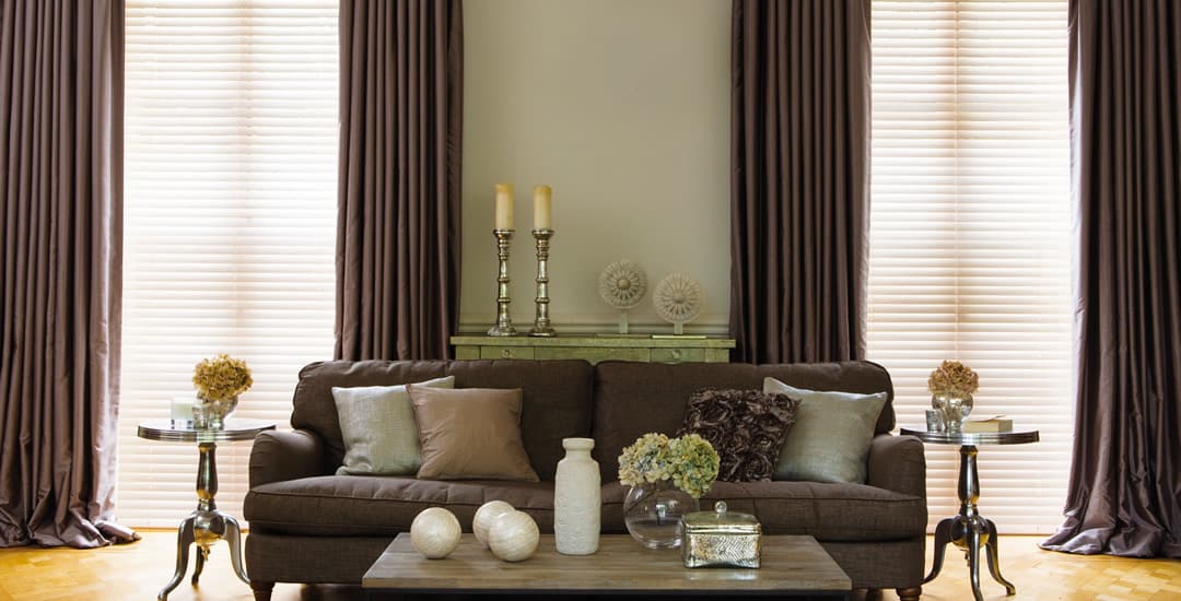 Luxury wooden blinds and curtains in traditional living room