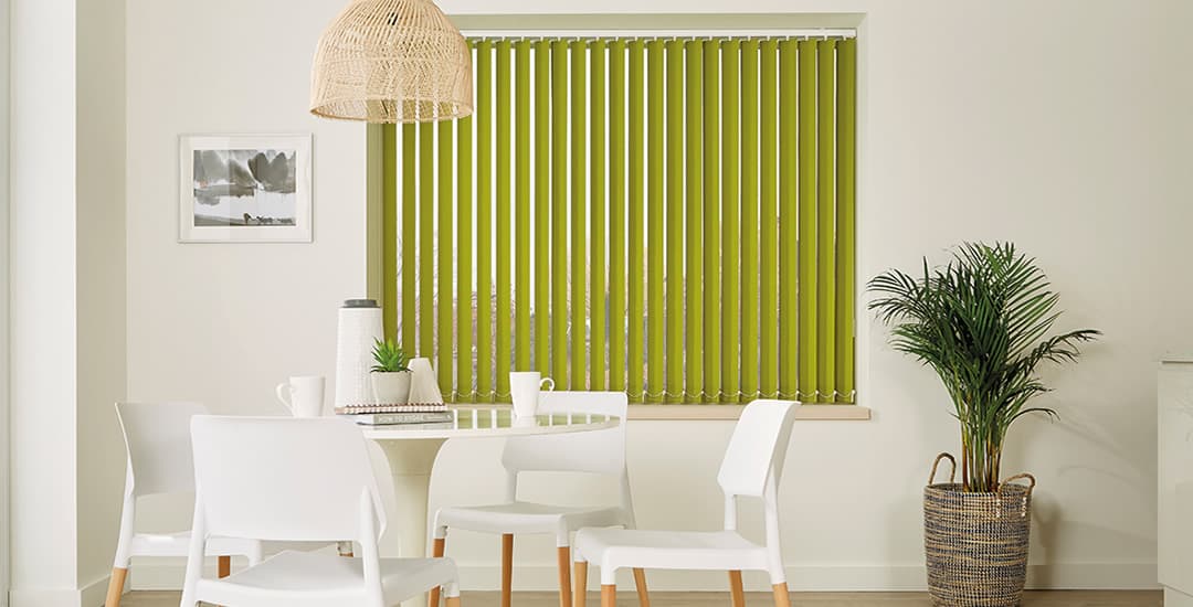 Partially opened lime green vertical blinds in modern white dining room