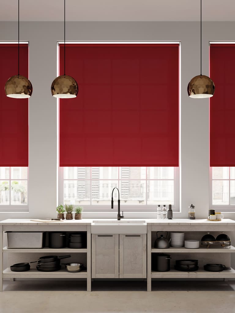 Red thermal roller blinds in a large modern kitchen