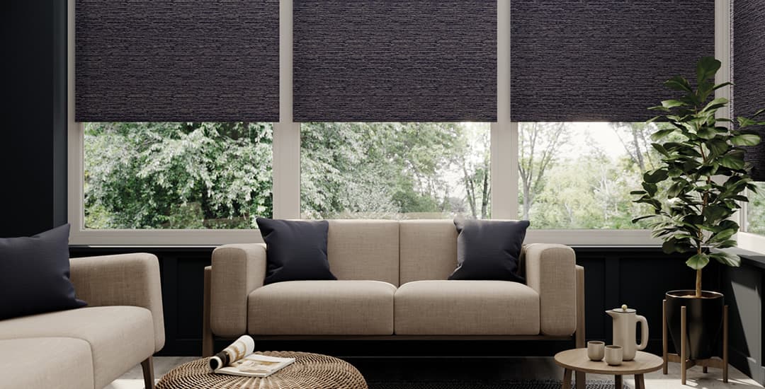 Luxury textured blackout roller blinds in a sunroom
