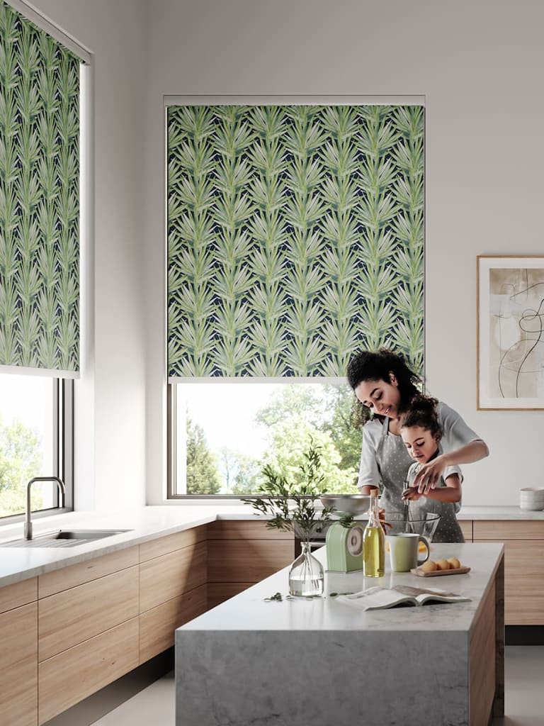 Tropical leaves patterned roller blinds in a large contemporary kitchen