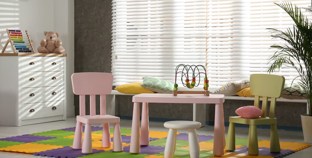 White faux wood blinds in children’s playroom