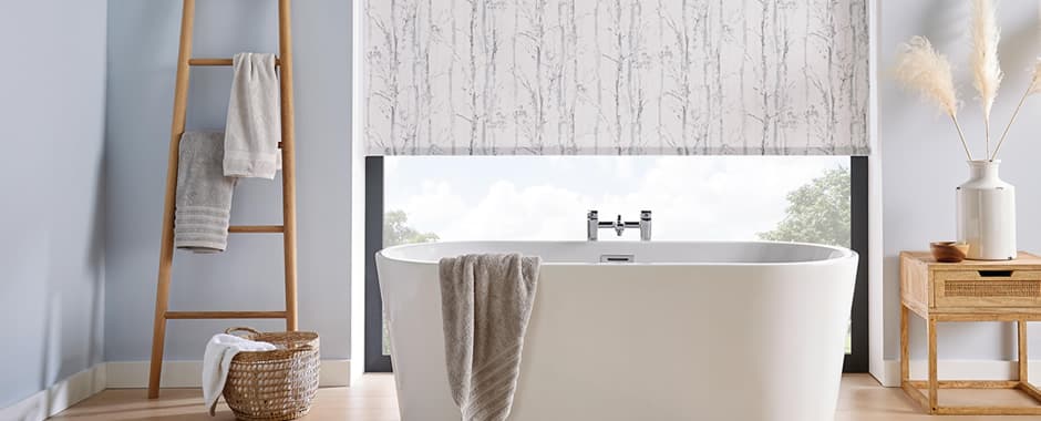 Birch tree patterned roller blinds in a white and blue bathroom