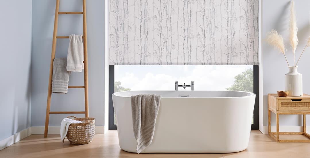 Birch tree patterned roller blinds in a white and blue bathroom