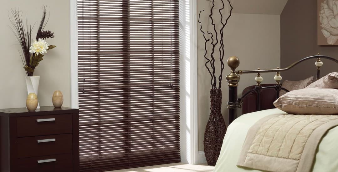 Brown made-to-measure aluminium Venetian blinds in a bedroom