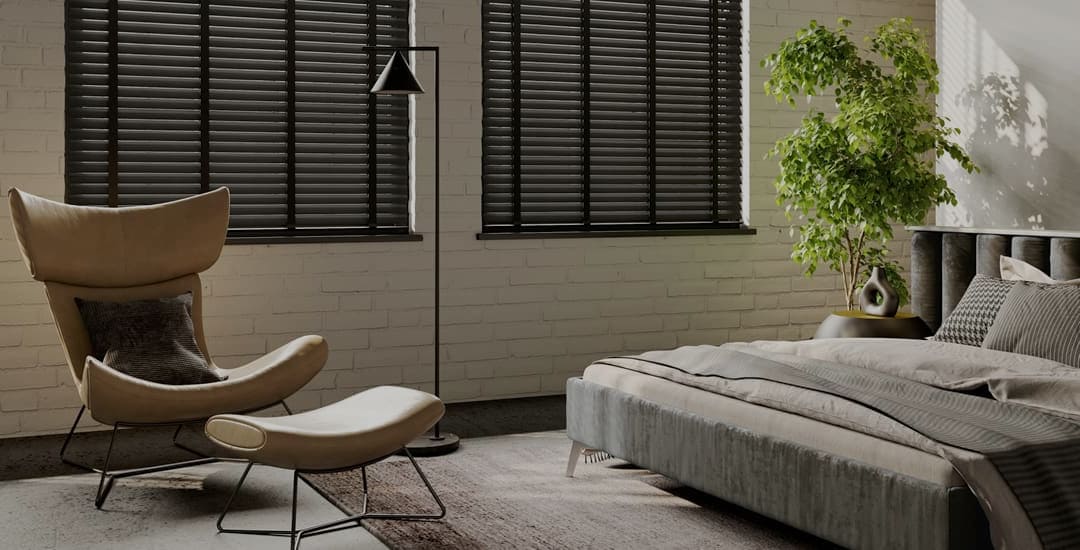 Closed black wooden Venetian blinds with tapes in a bedroom