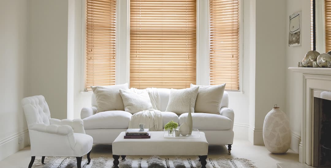 Pine real wood venetian blinds in a lounge bay window