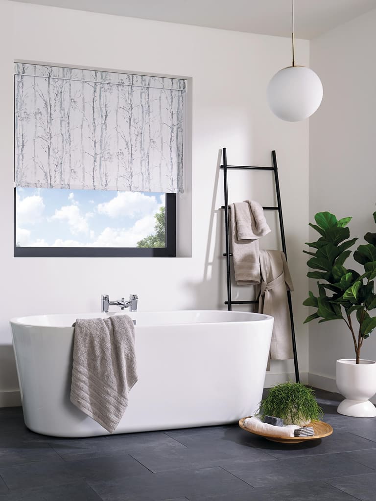 Swedish birch patterned roller blinds in white bathroom with plants