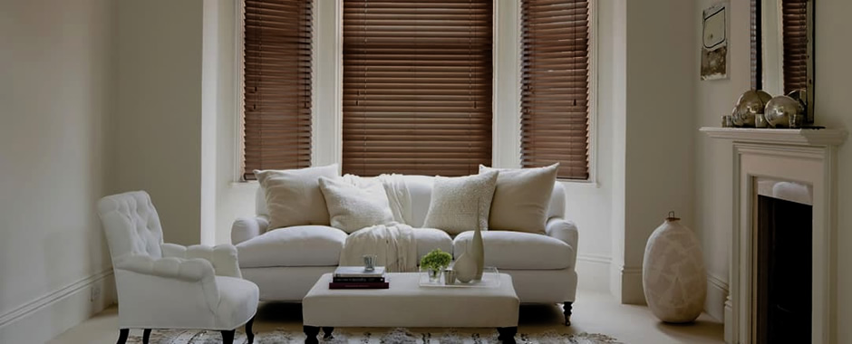 Walnut wooden blinds in a darkened cream living room