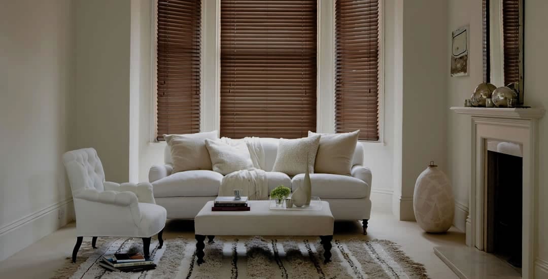 Walnut wooden blinds in a darkened cream living room