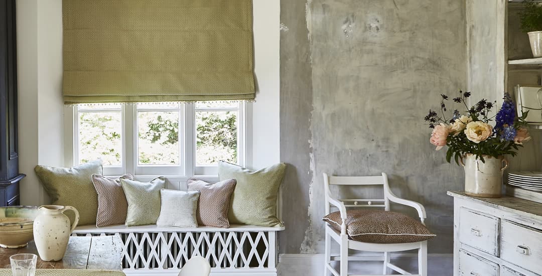 Luxury plain fabric Roman blind in a rustic dining room