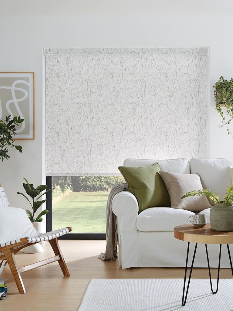 Sweet pea green pattern roller blinds in a white living room with lots of plants