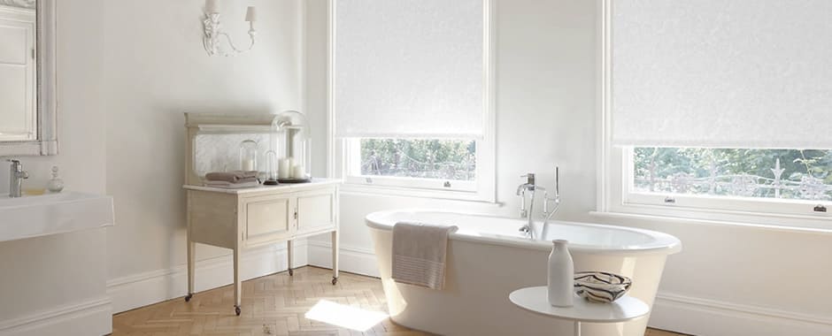 White PVC waterproof roller bathroom blinds in a large traditional bathroom