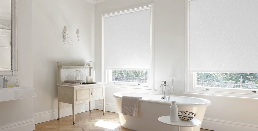 White PVC waterproof roller bathroom blinds in a large traditional bathroom