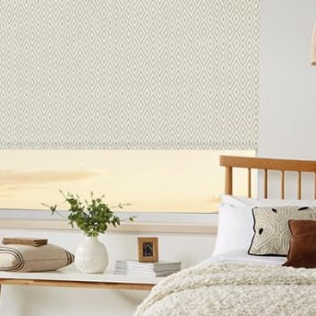 Aztec-inspired patterned roller blinds in a colour-matched bedroom