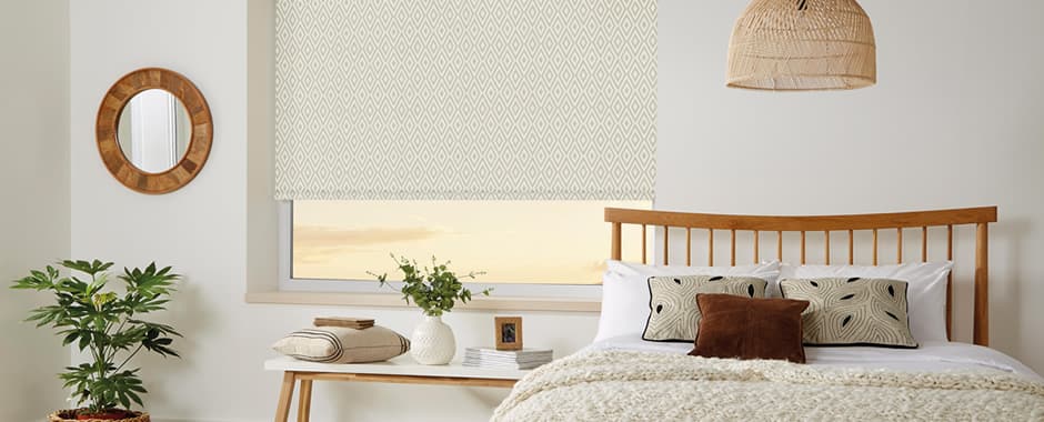 Aztec-inspired patterned roller blinds in a colour-matched bedroom