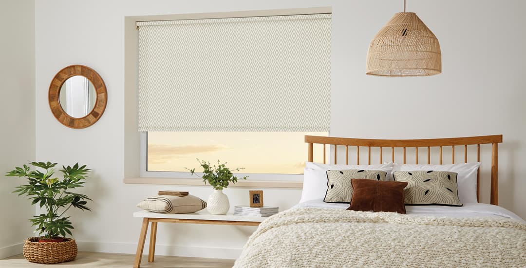 Aztec-inspired patterned roller blinds in a colour-matched bedroom