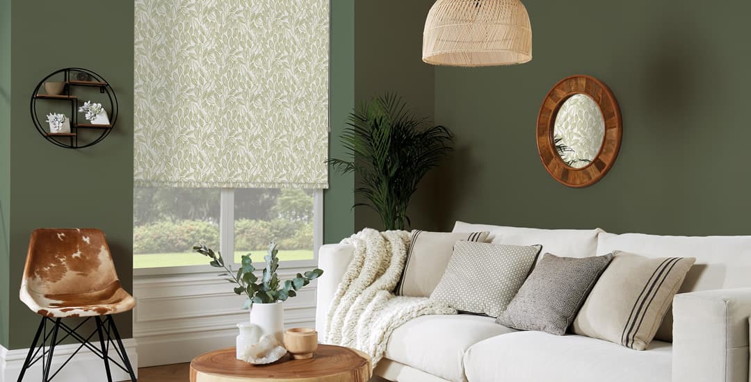 Green leaf patterned roller blinds in green and white living room