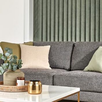 Green vertical blinds in a white and grey living room