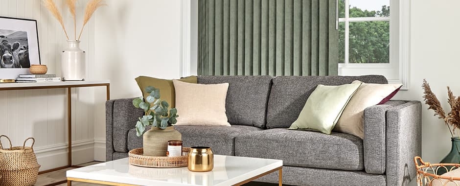 Green vertical blinds in a white and grey living room