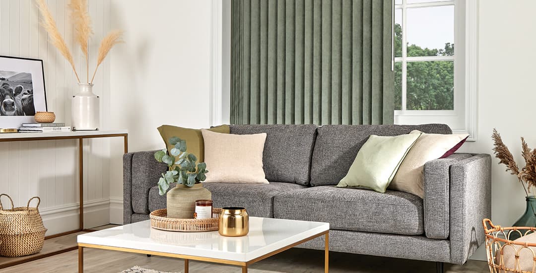 Green vertical blinds in a white and grey living room