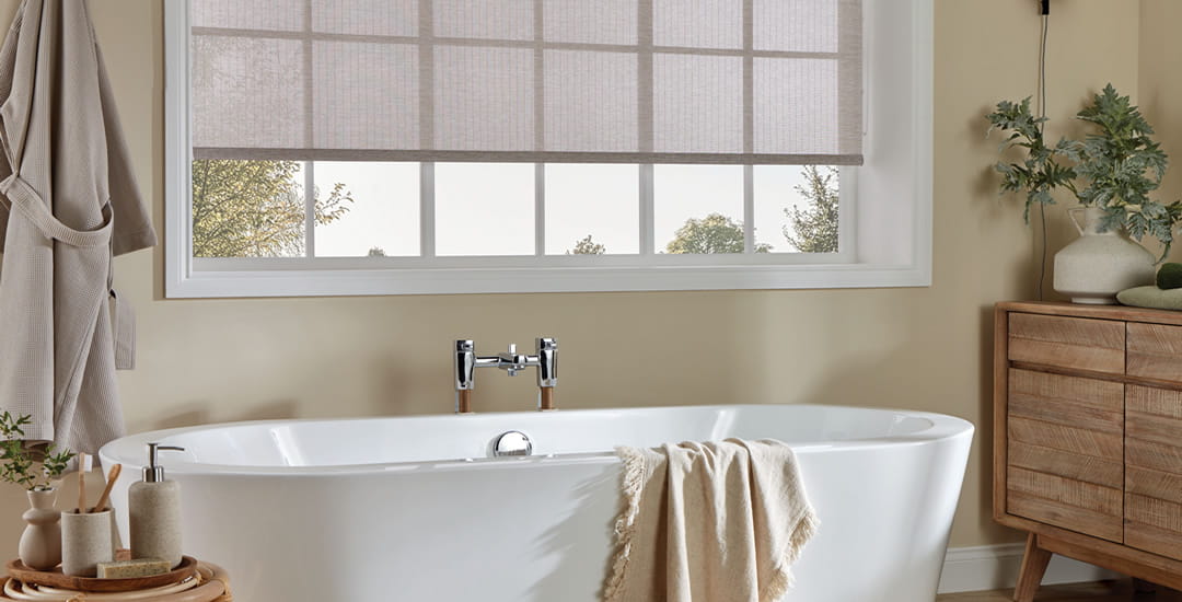 Stylish sheer fabric roller blind in a cosy bathroom