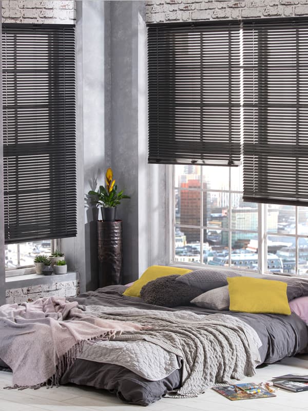 Dark grey venetian blinds in a rustic modern bedroom