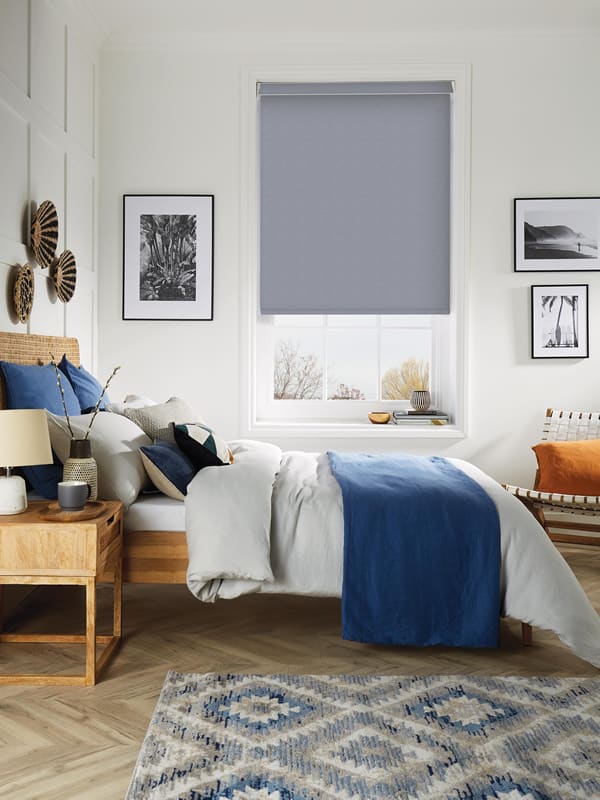 Grey thermal blackout blinds in a stylish blue white bedroom