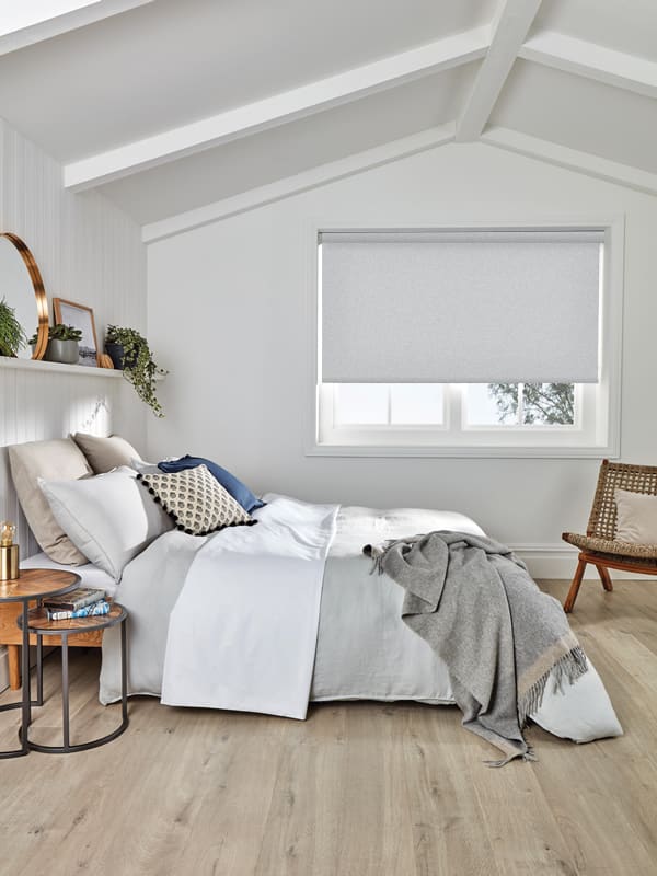 Grey blackout blinds in a stylish white wood panelled bedroom