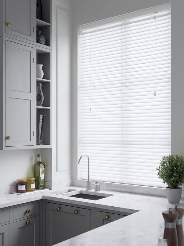 Cheap priced White faux wood blinds in a Birmingham kitchen window