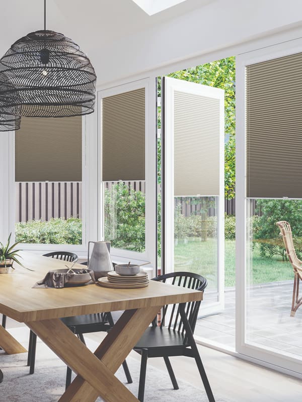 Beige perfect fit pleated blinds in conservatory