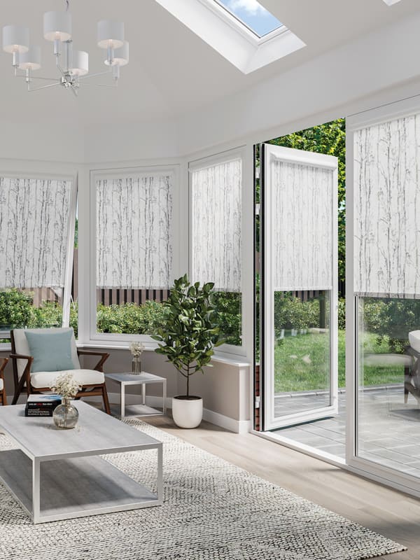 Luxury patterned roller blinds in conservatory