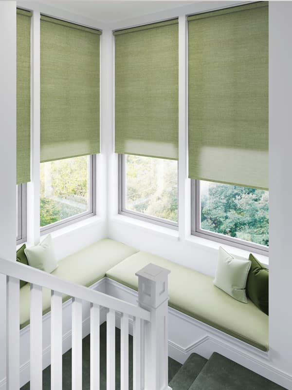 Textured green fabric roller blinds on a landing