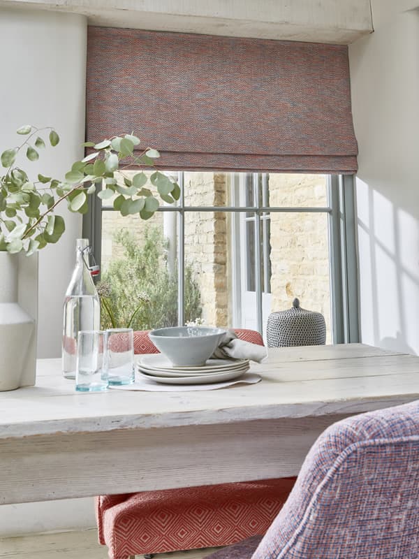 Luxury fabric Roman blinds in a rustic dining room