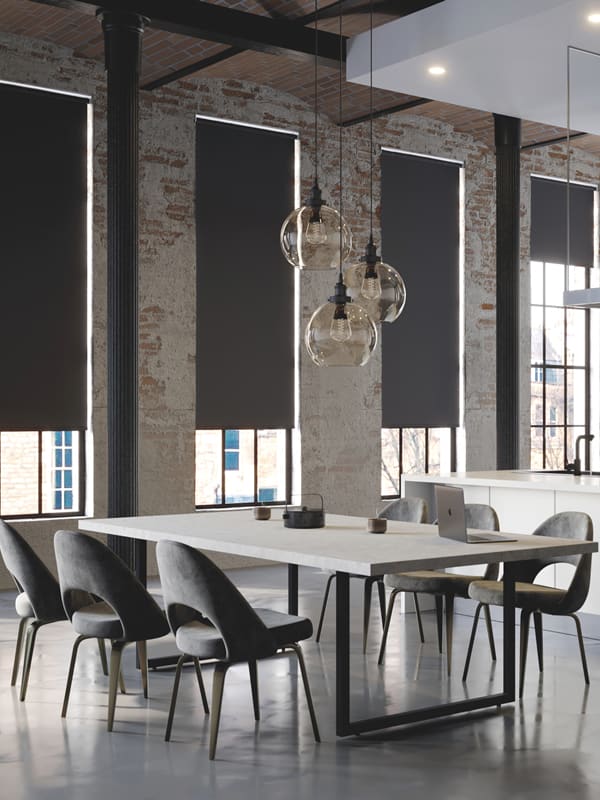 Quality black fabric roller blinds in a modern dining room