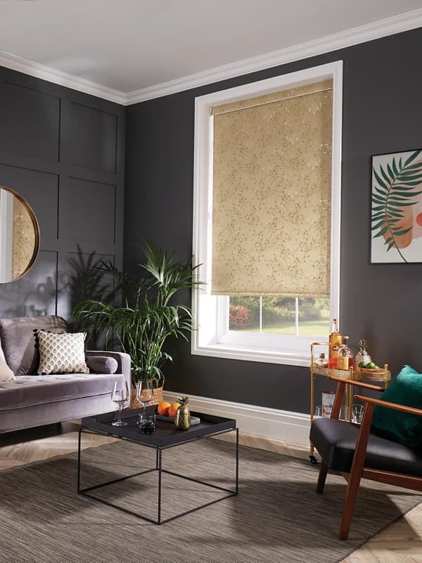 Gold patterned roller blinds in a dark wood-panelled living room