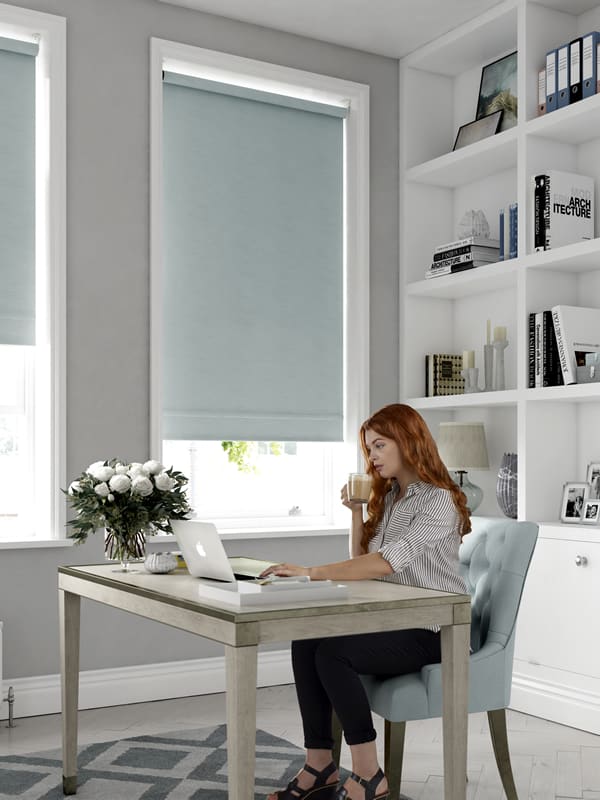Duck egg blackout roller blinds in a home office