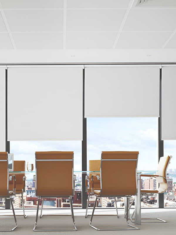 White contract blackout roller blinds in conference room