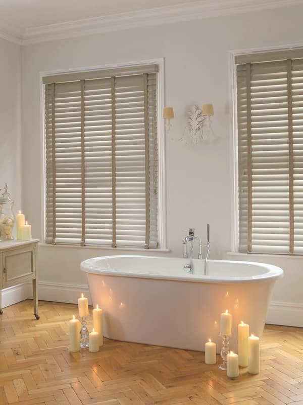 Beige slatted faux wood blinds with tapes in bathroom